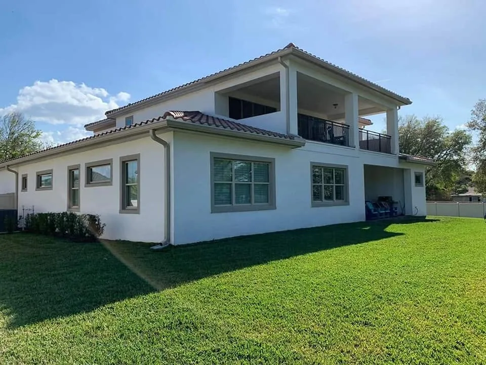 White stucco two story barrel tile roof seamless gutters, Sanford